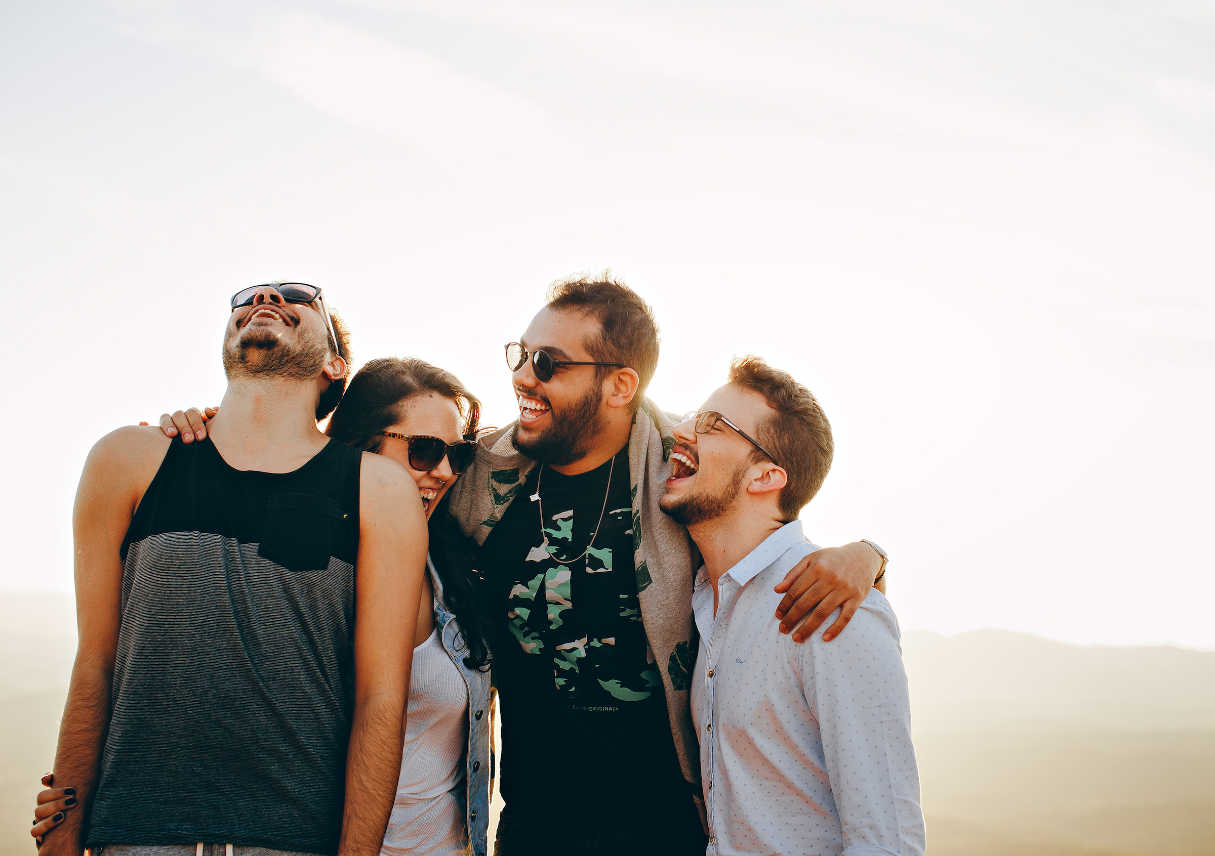 friends laughing together on a white background